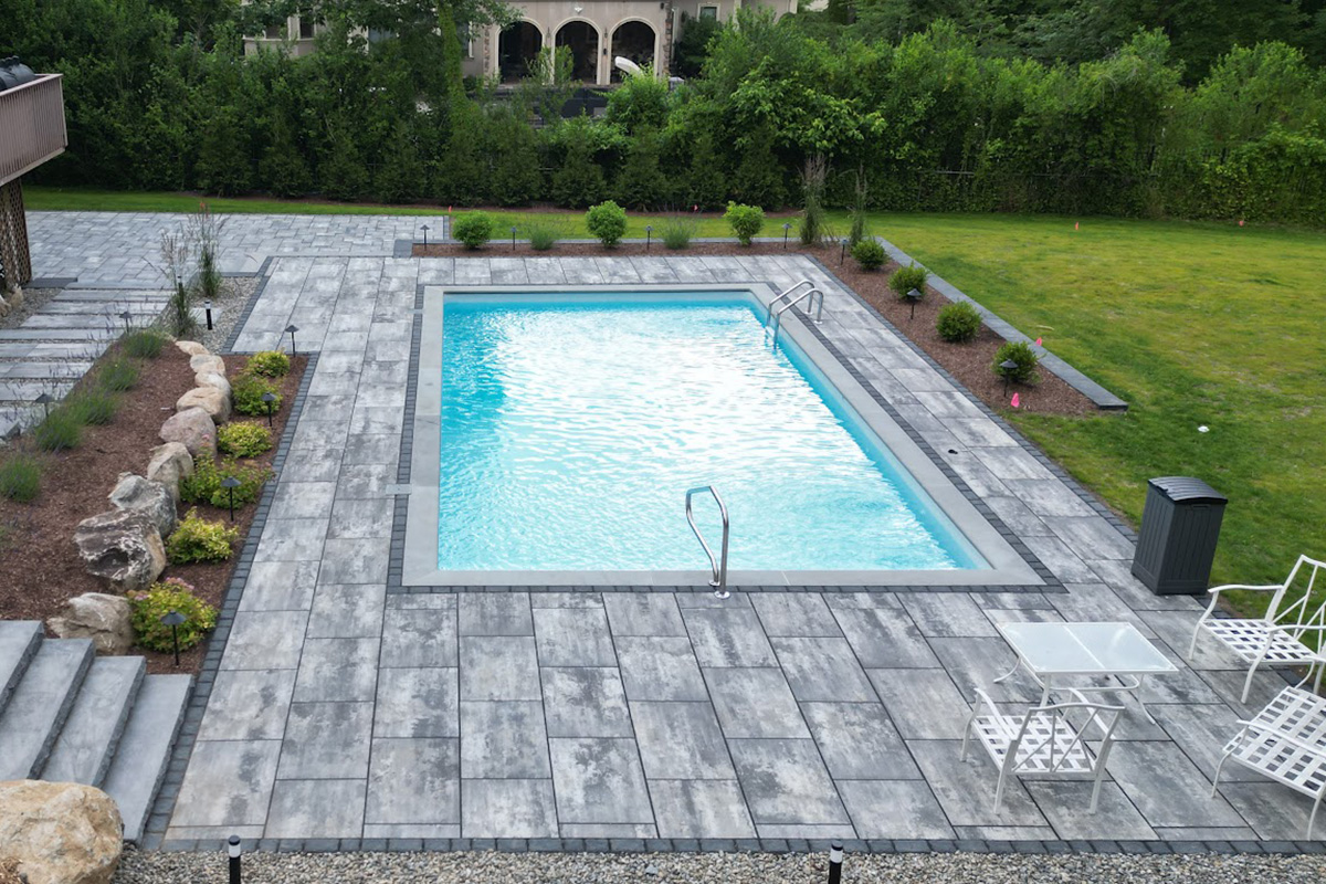 a swimming pool with a lawn and grass