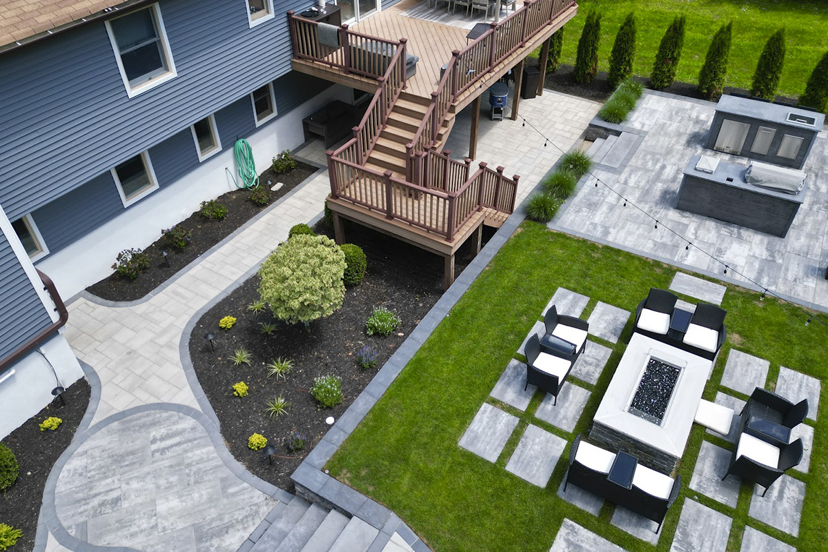 a patio with a deck and a table and chairs