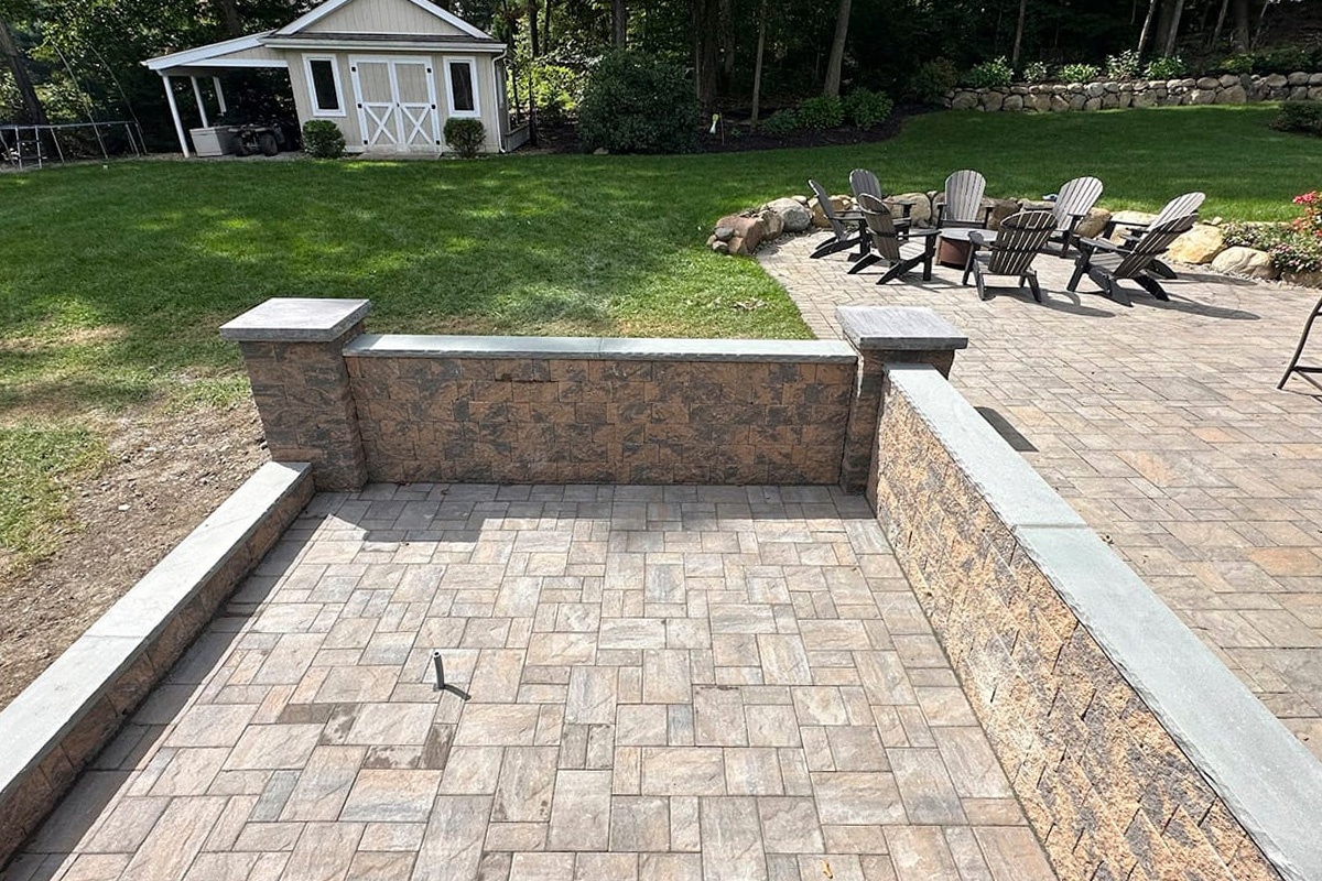a patio with chairs and a house in the background