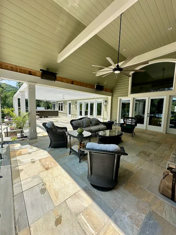 Homeowner sweeping backyard patio in Ridgewood NJ